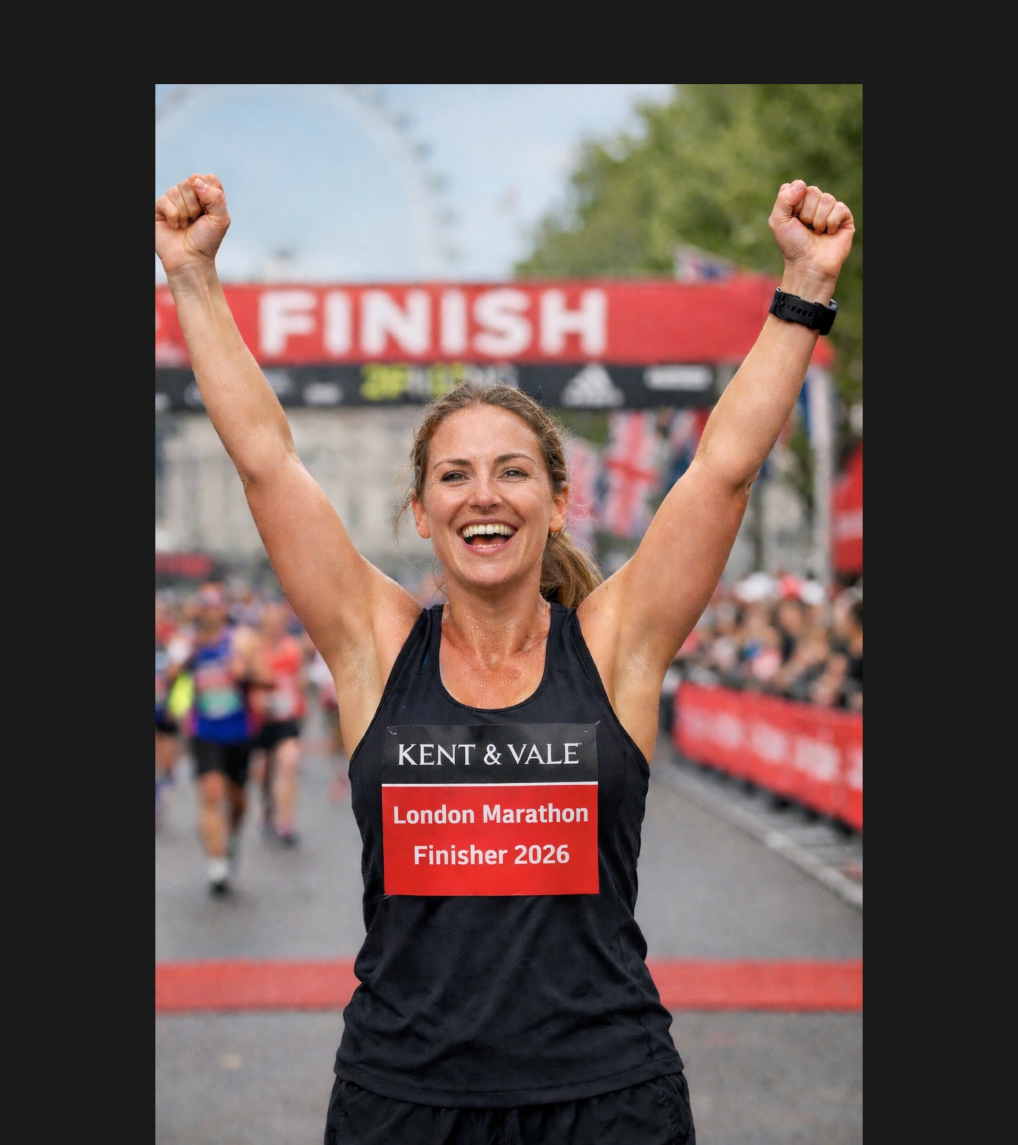 London Marathon 2026 finisher celebrating at the finish line wearing a Kent & Vale vest